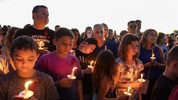   People attend a candlelit memorial service Thursay night for the victims of the shooting at Marjory Stoneman Douglas High School that killed 17 people.