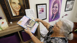In this Monday, Aug. 6, 2018 photo, Susan Bro, mother of Heather Heyer, who was killed during the Unite the Right rally last year, looks over memorabilia in her office in Charlottesville, Va.
