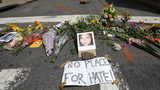 Flowers surround a photo of 32-year-old Heather Heyer, who was killed when a car plowed into a crowd of people protesting against the white supremacist Unite the Right rally, August 13, 2017 in Charlottesville, Virginia.