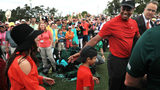 Tiger Woods (R) of the United States celebrates with his girlfriend Erica Herman (L) and son Charlie Axel (C) as he comes off the 18th green in celebration of his win during the final round of the Masters at Augusta National Golf Club on April 14,